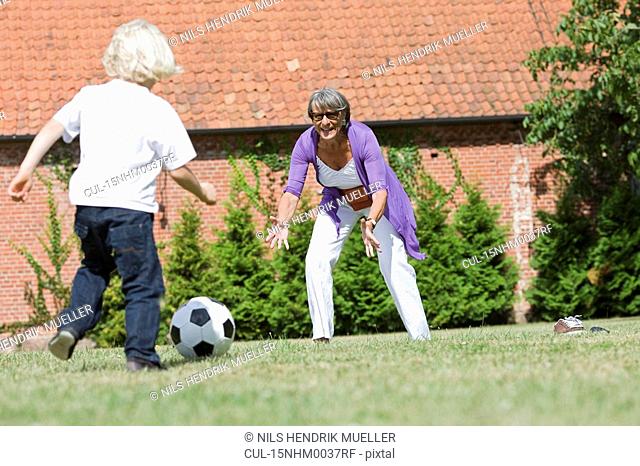 grandmother and child playing football