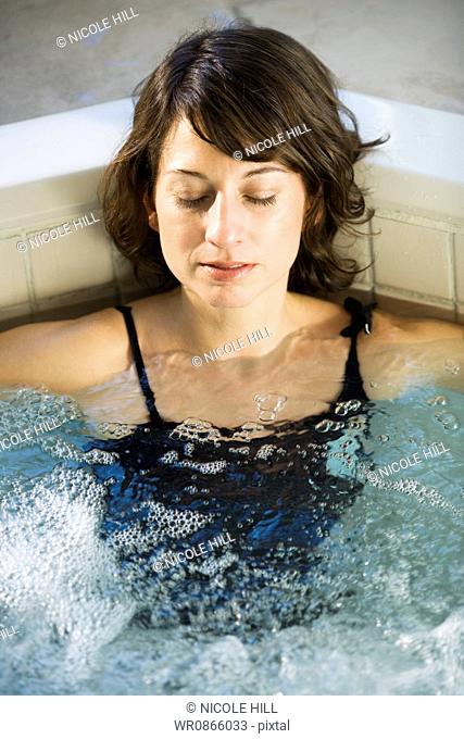 Woman relaxing in whirlpool