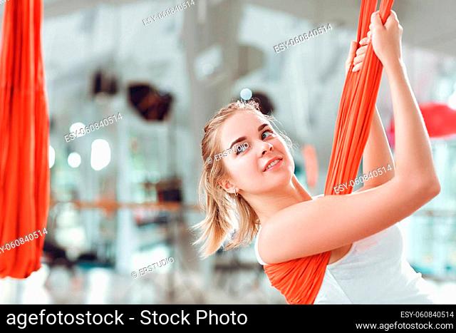 Fly yoga. Young woman practices aerial anti-gravity yoga with a hammock