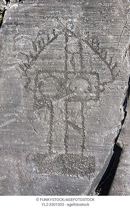 Petroglyph, rock carving, of a house on stilts. Carved by the ancient Camuni people in the iron age between 1000-1200 BC
