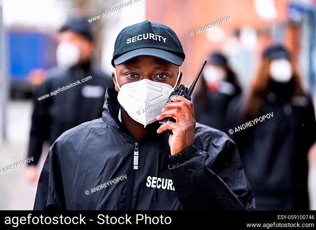 Security Officer Staff Group At Event In Face Mask