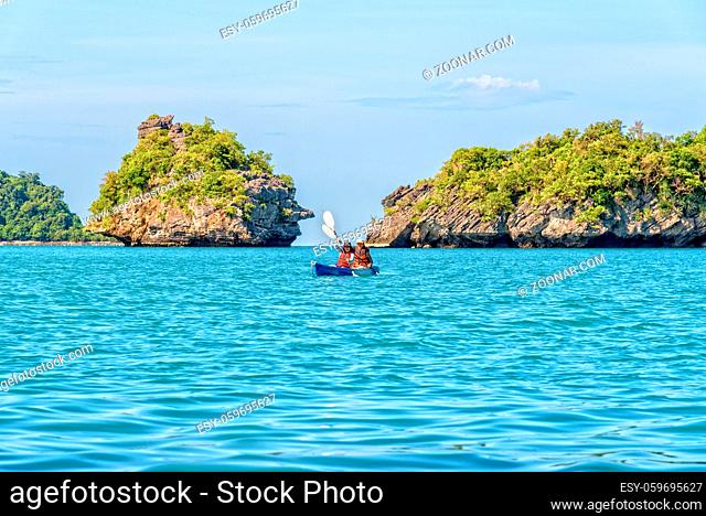 Two women are mother and daughter. Travel by boat with a kayak around island enjoy view the beautiful natural landscape of the blue sea at summer