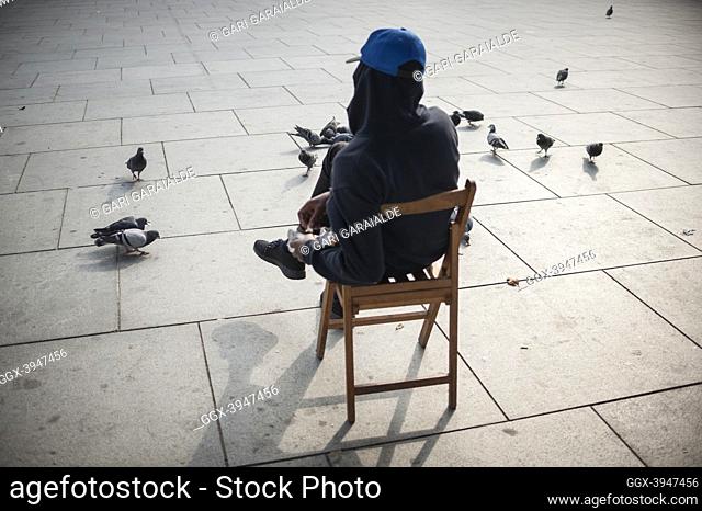 An African migrant feeding pigeons. Irun (Spain). October 23, 2018. As the number of migrants arriving on the coasts of southern Spain increased