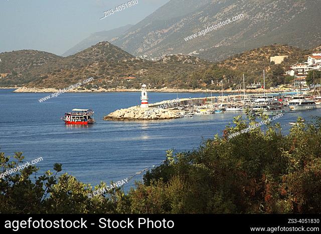 Daily excursion boats leaving the small port of Kas village with the lighthouse at the background, Antalya Province, Mediterranean Coast, Ancient Lycia Region