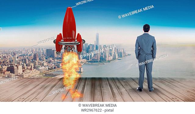 Digital composite image of businessman standing by rocket launch on pier while looking at sea and ci