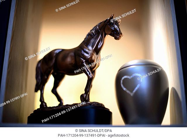 A horse figure stands next to an urn for animal funerals at the nationwide first animal crematory which allows the cremation of horses in Schwaebisch Hall
