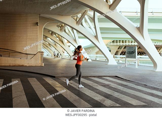 Spain, Valencia, woman running at Ciudad de las Artes y de Las Ciencias