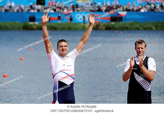 Czech Republic's Ondrej Synek left, who won a silver medal, and New Zealand gold medalist Mahe Drysdale celebrate after the men's rowing single sculls finals in...