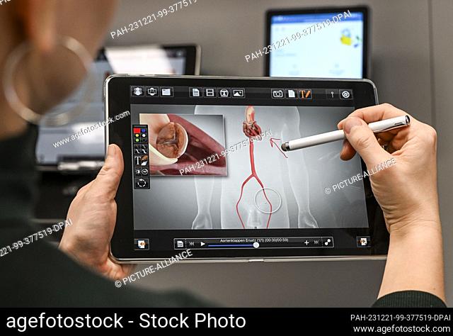 PRODUCTION - 13 December 2023, Berlin: A digital tool is shown on a tablet in the e-health show practice of the Berlin Association of Statutory Health Insurance...