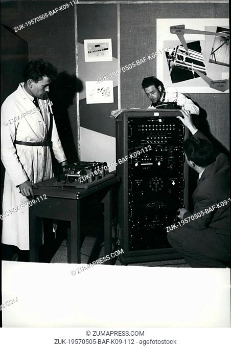 May 05, 1957 - Exhibition Of Modern Physics Opens Et Grand Palais. Photo Shows: Engineers of an electronic Firi installing an electronic machine to be seen at...