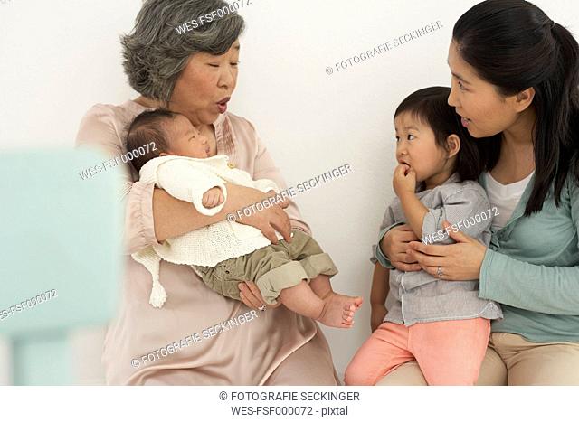 Asian senior woman with daughter and two granddaughters