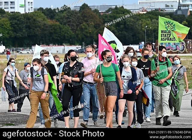 13 March 2020, Bavaria, Munich: A group of the BUND youth walks across the Theresienwiese. A demonstration and a bicycle rally against the International Motor...