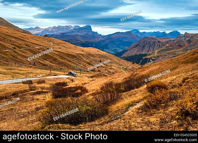 Autumn alpine Dolomites mountain scene near Pordoi Pass, Trentino, Italy. Picturesque traveling, seasonal, nature and countryside beauty concept scene