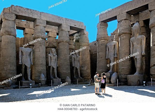 Luxor, Egypt. Temple of Luxor (Ipet resyt): three staues of the King Ramses II in the first courtyard