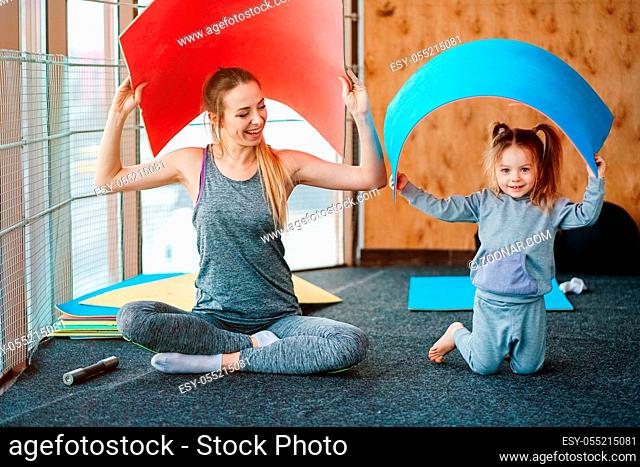 little girl and mom having fun in the gym
