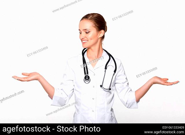 young woman doctor showing choice between two objects