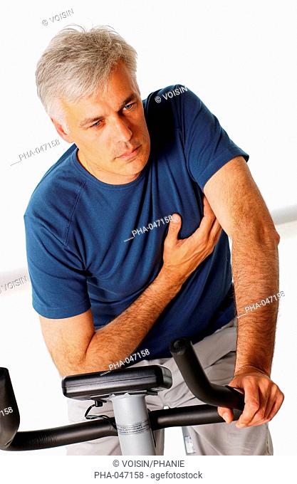 Man suffering from a heart attack when practising excercize bicycle