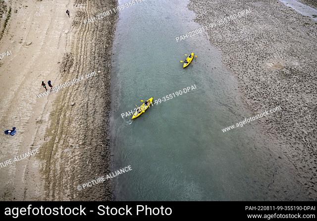 11 August 2022, France, Aiguines: Two canoes navigate the meager remnant of the Verdon River at the head of the Lac de Sainte-Croix reservoir