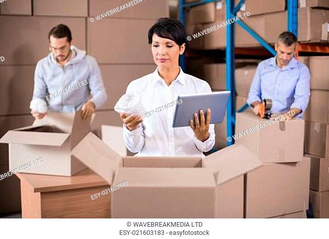 Warehouse workers packing up boxes