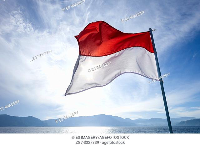 Indonesian flag waving over Lake Toba and Samosir Island, Sumatra, Indonesia
