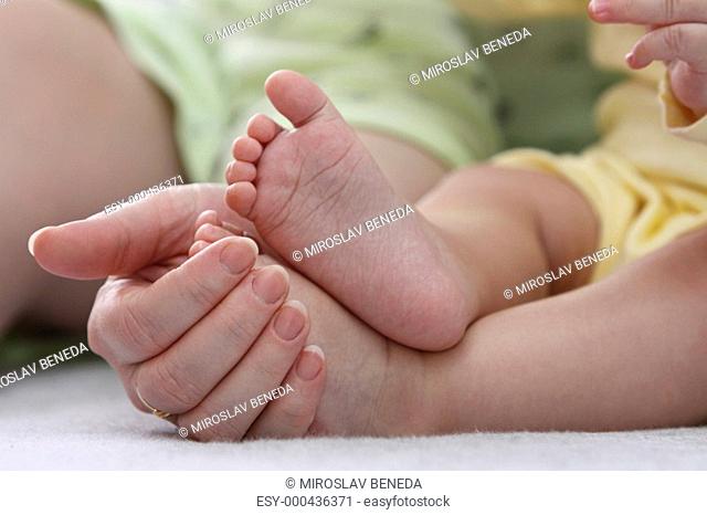 Mother holding her childs feet