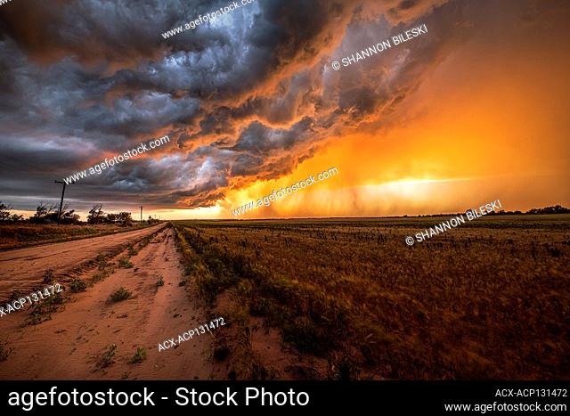 Storm dying at sunset with incoming rain core in Texas United States