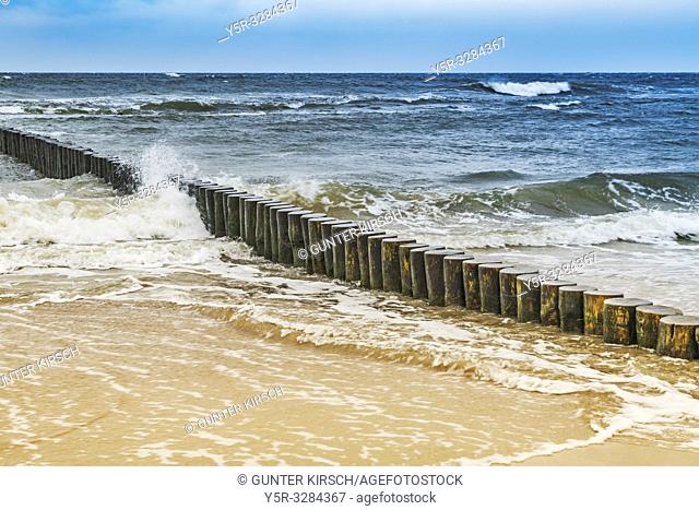 Sandy Beach with groynes on the Baltic Sea. Groynes are intended to break the shaft and to prevent the erosion of the coast
