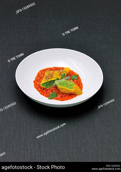 Maultaschen with pike sauce on tomato sauce