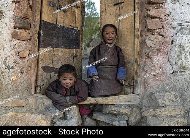 Portrait, children in front of a wooden door, Saldang, Dolpo, Nepal, Asia
