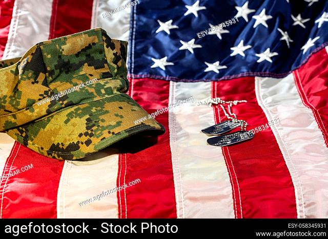 Military cover on an American Flag with dog tags