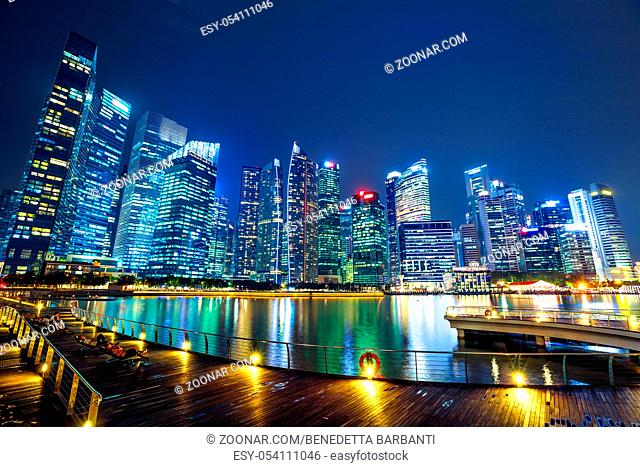 People enjoy the view of central business district from marina bay waterfront promenade in front of bayfront south jetty