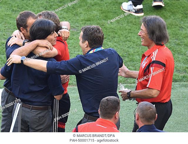 Head coach Joachim Loew (2-L) of Germany celebrates with assistant coach Hansi Flick (L), team manager Oliver Bierhoff (2-R) and team doctor Hans-Wilhelm...
