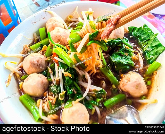 Popular street food in Thailand (Kuai Tiao Moo Namtok) that consisted of pork ball, pork meat, basil or thyme, bean sprouts, morning glory