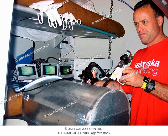 NEEMO-9 astronautaquanaut Ronald J. Garan Jr. works with a Center for Minimal Access Surgery (CMAS) experiment in the National Oceanic and Atmospheric...