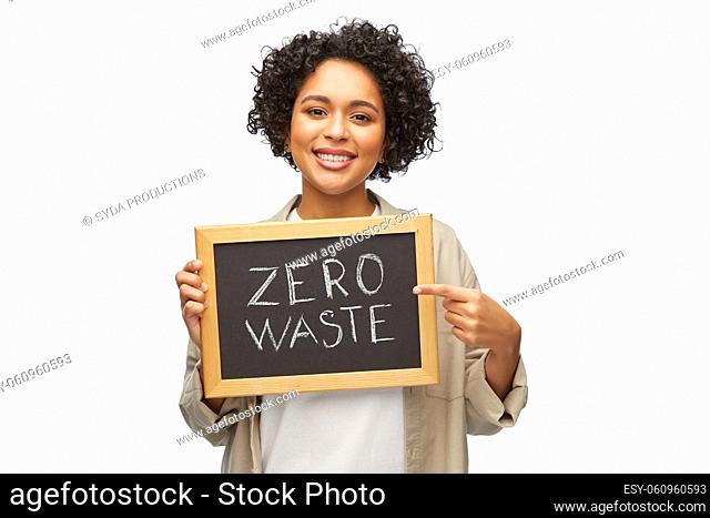woman with zero waste words on chalkboard
