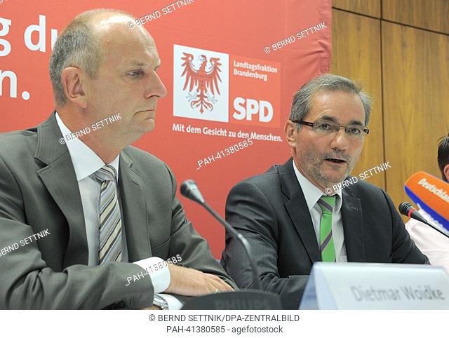 Governor of Brandenburg Matthias Platzeck (R) sits next to Brandenburg's Minister of Interior Dietmar Woidke during a press conference held in rooms of the SPD...