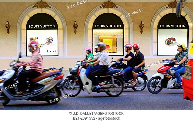 Vietnam. Hanoi. ""Louis Vuiton"" shop and motorcyclists