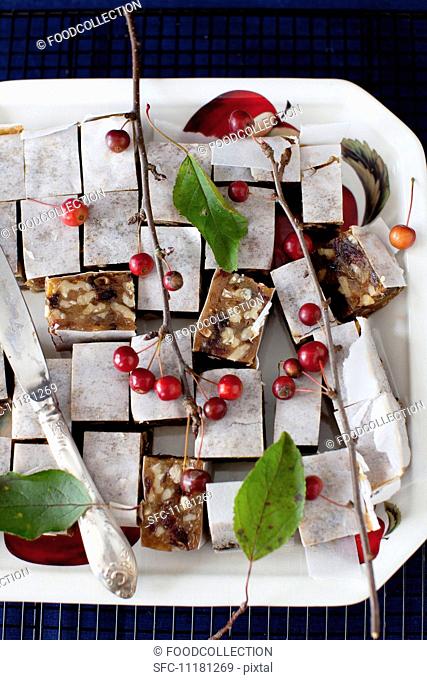 Panforte Squares on a Platter with Berries and a Knife