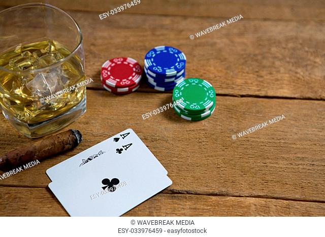 High angle view of whisky by cards and chips