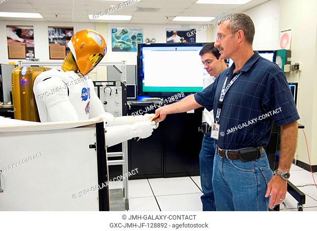 NASA astronaut Dan Burbank (foreground), Expedition 29 flight engineer and Expedition 30 commander, participates in a Robonaut familiarization training session...