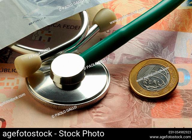 Stethoscope on Brazilian banknotes and coins