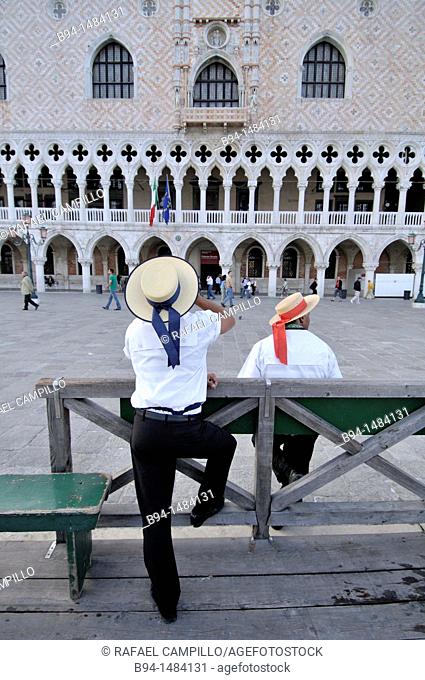 Gondoliers on Riva degli Schiavoni in front of the Doge's Palace, Venice, Veneto, Italy