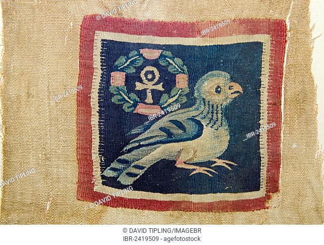 Textile panel depicting a bird with the wreathed cross that takes the form of the pharaonic ankh, the symbol for life, dating from 5 - 7th century AD from...