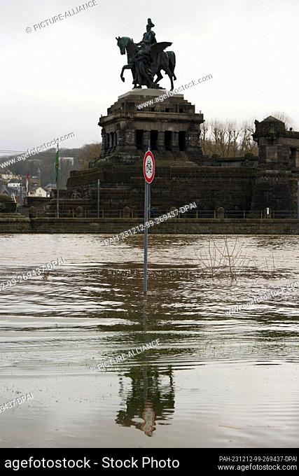 12 December 2023, Rhineland-Palatinate, Koblenz: A cycle path opposite the Kaiser Wilhelm monument at the Deutsches Eck is flooded