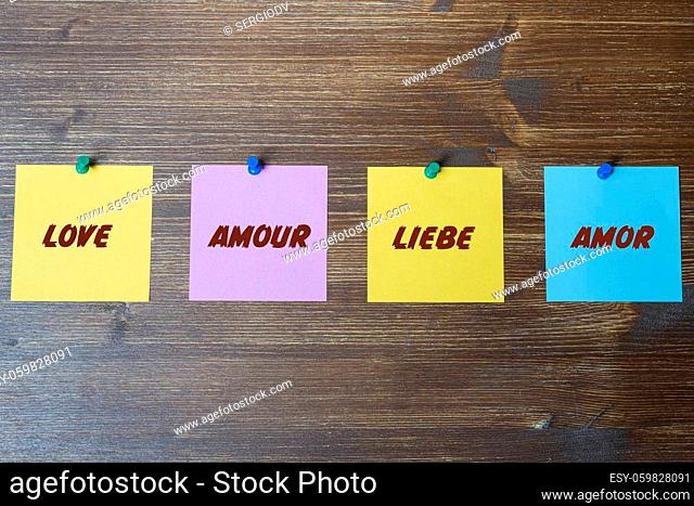 some colorful cards with the word love written on it in English, French, German and Spanish languages