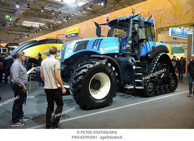 Visitors check out the latest tractors at the New Holland stall at the Agritechnica agricultural technology fair in Hanover, Germany, 8 November 2015