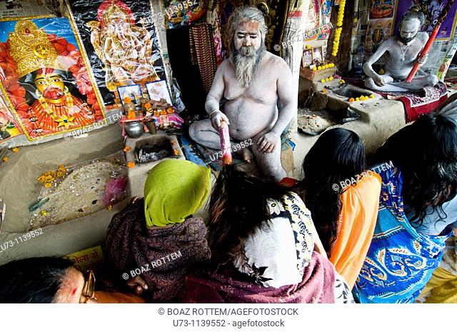 Pilgrims being blessed by a naked naga sadhu