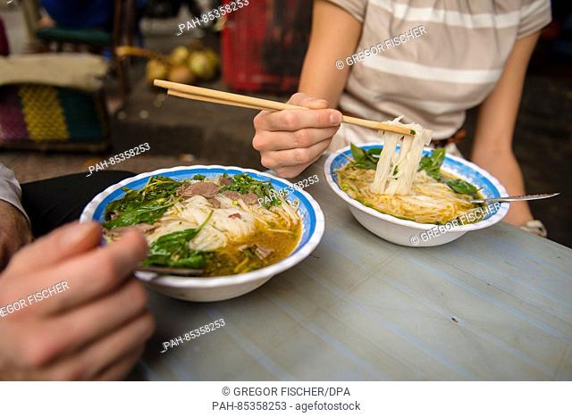 Two bowls of rice noodles and soup on a restaurant table in Ho Chi Minh City, Vietnam, 01 November 2016. Photo: Gregor Fischer/dpa | usage worldwide