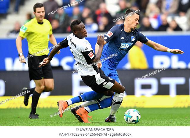 Hoffenheim's Sandro Wagner (r) and Gladbach's Denis Zakaria vie for the ball during the Bundesliga soccer match between 1899 Hoffenheim and Borussia...