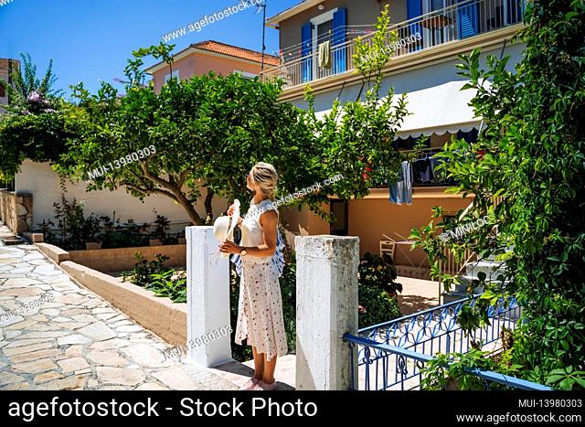 A tourist woman enjoyed small traditional village of Fiskardo, Kefalonia, Greece, during summer vacation time